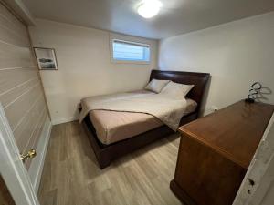 a small bedroom with a bed and a window at Nanaimo Nest in Nanaimo