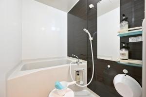 a bathroom with a tub and a toilet and a sink at アロハベース in Takamatsu +17 photos