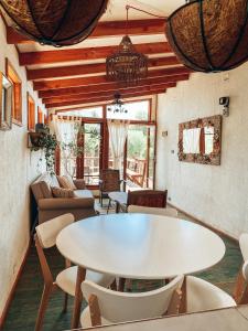 a living room with a white table and chairs at Malibu Hostal Boutique in Maitencillo +20 photos
