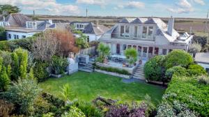 an aerial view of a house with a yard at Higher Close in Mawgan Porth