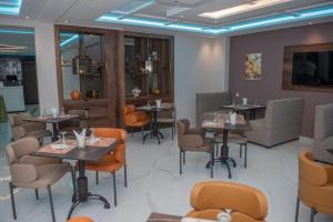 a dining room with tables and chairs at Hotel Rherssllah 
