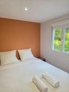 a bedroom with a large white bed with two pillows at Camping du Pas Del Fang in Sainte-Marie-la-Mer +46 photos