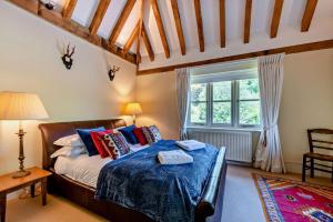 a bedroom with a bed and a large window at Denswood House in Brightling +47 photos