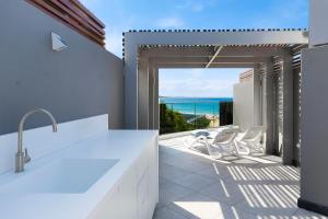 a kitchen with a view of the ocean at 71 Hastings - Beachfront in Noosa Heads +130 photos