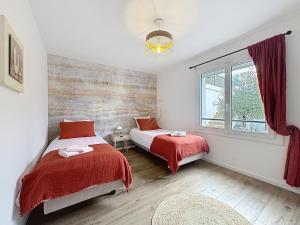 a bedroom with two beds and a window at HorizSky Villa, 6p, 3BR, pool, WiFi in Saint-Raphaël