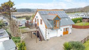 an aerial view of a house with solar panels on the roof at Marazion Sail Loft in Marazion