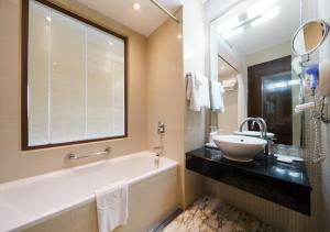 a bathroom with a tub and a sink and a window at Niagara Hotel in Seoul +6 photos
