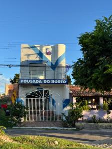 a building with a sign that reads pueblo do hotel at Pousada do Horto in Juazeiro do Norte