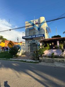 a building with a sign on the side of a street at Pousada do Horto in Juazeiro do Norte
