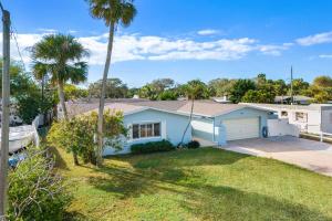 a house with a garage and a palm tree at 332 Formosa Drive in Cocoa Beach