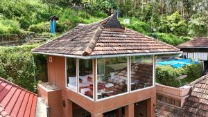 an aerial view of a house with a roof at Castillo De Woods , The Private Luxury Villa , 8 BHK, Vattavada in Kottakamboor