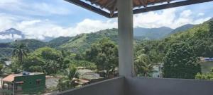a room with a view of mountains and trees at Recanto verde pousada in Angra dos Reis