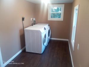a laundry room with a washer and dryer in it at Large downtown home in Philipsburg