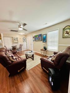 a living room with two couches and a table at Family Cottage 1 mile to Carolina Beach in Wilmington