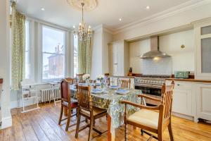 a dining room with a table and chairs and a kitchen at Sea Vista - Dovercourt in Harwich