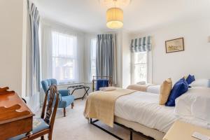 a bedroom with a bed and a table and chairs at Sea Vista - Dovercourt in Harwich