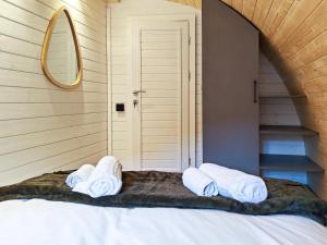 two towels on a bed in a room at Elm - Pantygelli Escapes in Abergavenny