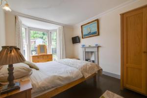 a bedroom with a bed and a window at Belvedere in New Quay