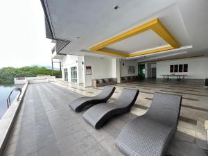 a large room with two chairs and water at Ipoh The Majestic Comfortable Homestay SY29 in Ipoh