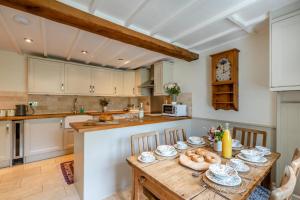 a kitchen with a wooden table in a kitchen at Bonnings Cottage in Barrington