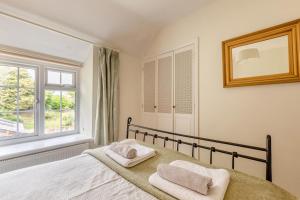 a bedroom with a bed with two towels on it at Bonnings Cottage in Barrington