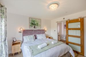 a bedroom with a bed with two pillows on it at Titw Tomos Las in Berriew