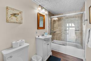 a bathroom with a sink and a toilet and a shower at Hydrangeas by the Sea in Barnstable +38 photos