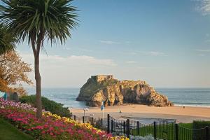a view of a beach with a castle on a rock at Mays Place in Tenby