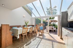 a kitchen and dining room with a table and chairs at Hoopers Cottage in Saint Brides