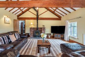 a living room with a couch and a fireplace at Willerby Grange Farm in Willerby