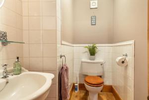 a white bathroom with a toilet and a sink at Willerby Grange Farm in Willerby +27 photos