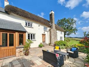 an exterior view of a house with a patio at Court in Chittlehampton