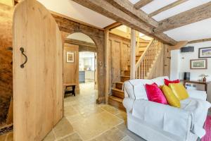 a living room with a white couch and a wooden door at Court in Chittlehampton