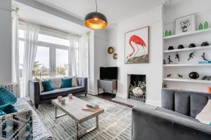 a living room with couches and a fireplace at White Water House in Pevensey