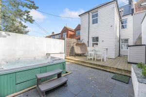 a hot tub in the backyard of a house at White Water House in Pevensey