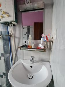 a bathroom with a white sink and a mirror at Room in Kapan, Near Boudhanath Stupa in Kathmandu +9 photos