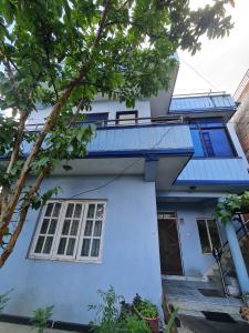 a blue and white house with a balcony at Room in Kapan, Near Boudhanath Stupa in Kathmandu