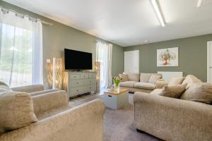 a living room with two couches and a flat screen tv at Magnolia - Bude in Bude