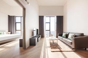 a living room with a couch and a table at Siamese Residence Sukhumvit 87 Bangkok in Bangkok