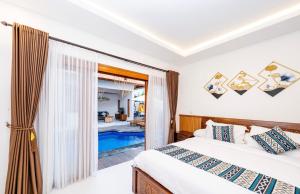 a bedroom with a bed and a swimming pool at Mesari Jinah Villa 2 in Ungasan +12 photos