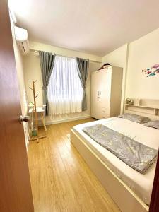 a bedroom with a large bed and a window at An's House In Phan Rang in Kinh Dinh