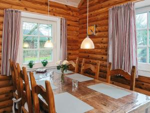 a dining room with a table in a log cabin at 6 person holiday home in Hovborg in Hovborg