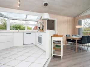 a kitchen and dining room with a table and chairs at 6 person holiday home in Bjert-By Traum in Binderup Strand