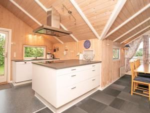 a kitchen with white cabinets and a stove at 8 person holiday home in Skals in Skals