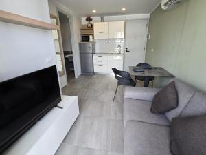 a living room with a couch and a table at Seabreeze Suite 1-Bed T3-637 in Phuket