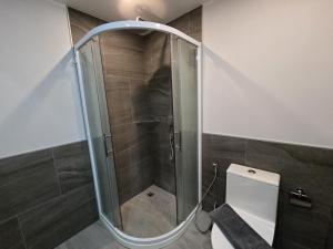a glass shower in a bathroom with a toilet at Seabreeze Suite 1-Bed T3-637 in Phuket +10 photos