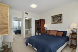 a bedroom with a blue bed and a bathroom at The Seagulls Nest Woorim in Woorim +3 photos