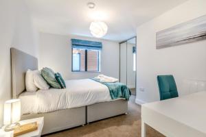 a bedroom with a bed and a desk and a chair at Beach Haven - C6 in Woolacombe +19 photos