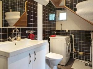 a bathroom with a sink and a toilet and a staircase at 4 star holiday home in Onsala in Onsala +10 photos