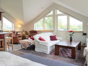 a living room with a white couch and a table at 4 star holiday home in Onsala in Onsala